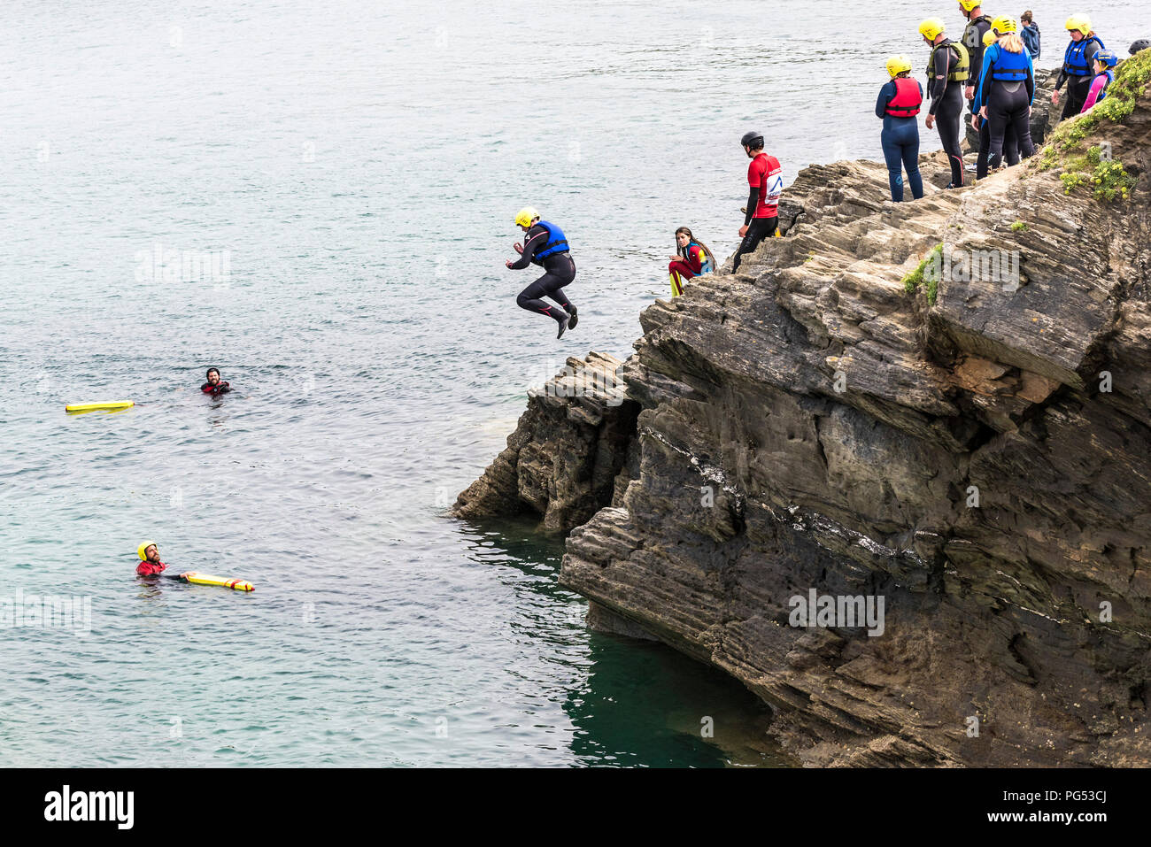 I villeggianti coasteering sul promontorio in Newquay, Cornwall. Foto Stock