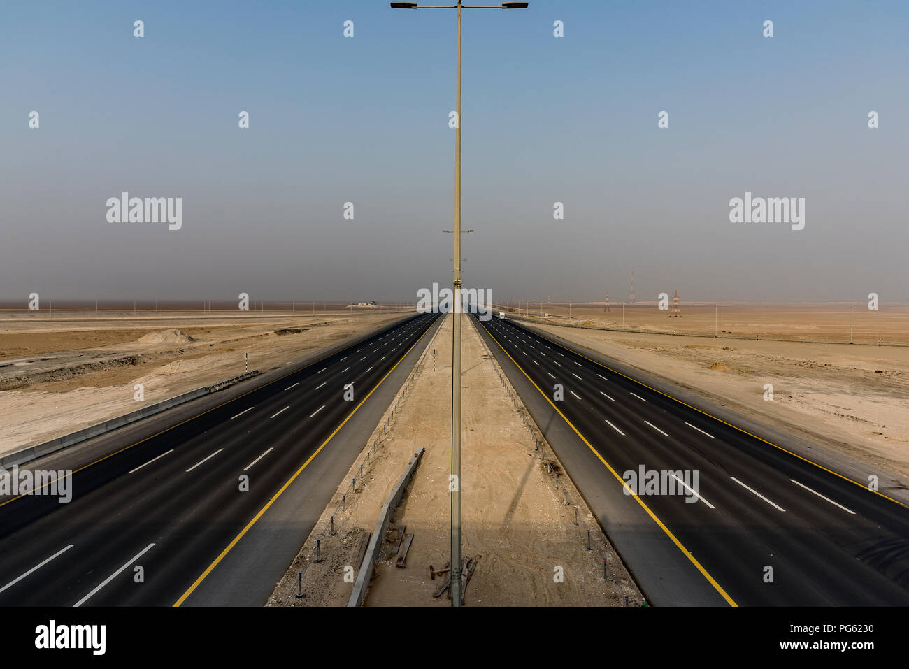 Mafraq-Ghweifat autostrada internazionale, Emirati Arabi Uniti.Il limite di velocità è di 160 km/h su una superficie pulita, liscia e piatta a 8 corsie. Foto Stock