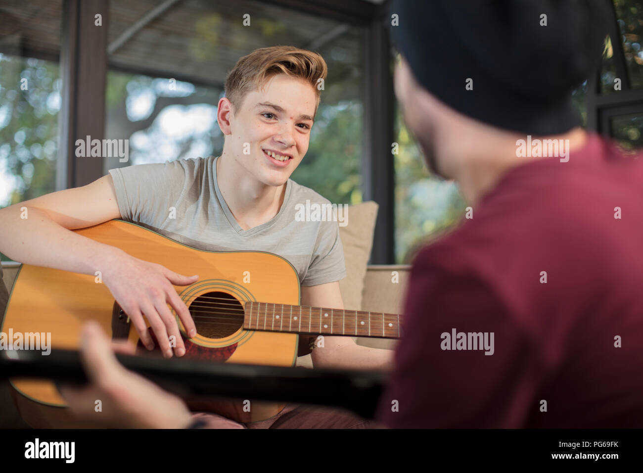 Musicista studente di insegnamento come suonare la chitarra Foto Stock