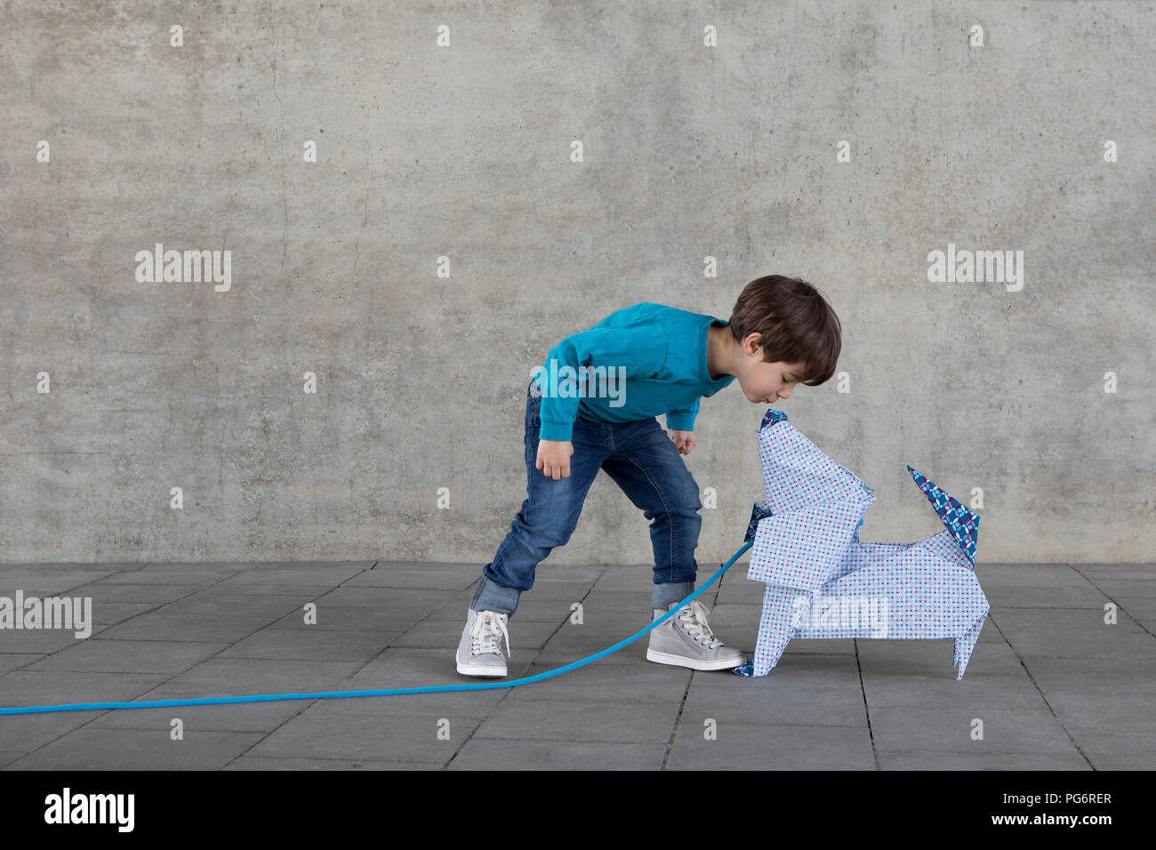 Little Boy kissing origami cane Foto Stock