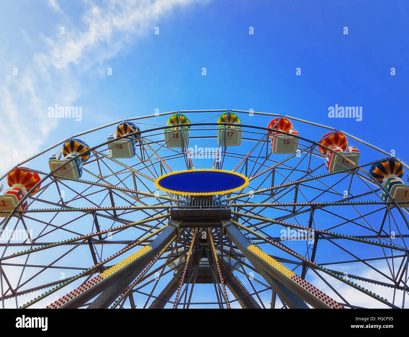 Vista ravvicinata di una grande ruota panoramica Ferris al di sopra di un profondo cielo blu sullo sfondo. Foto Stock