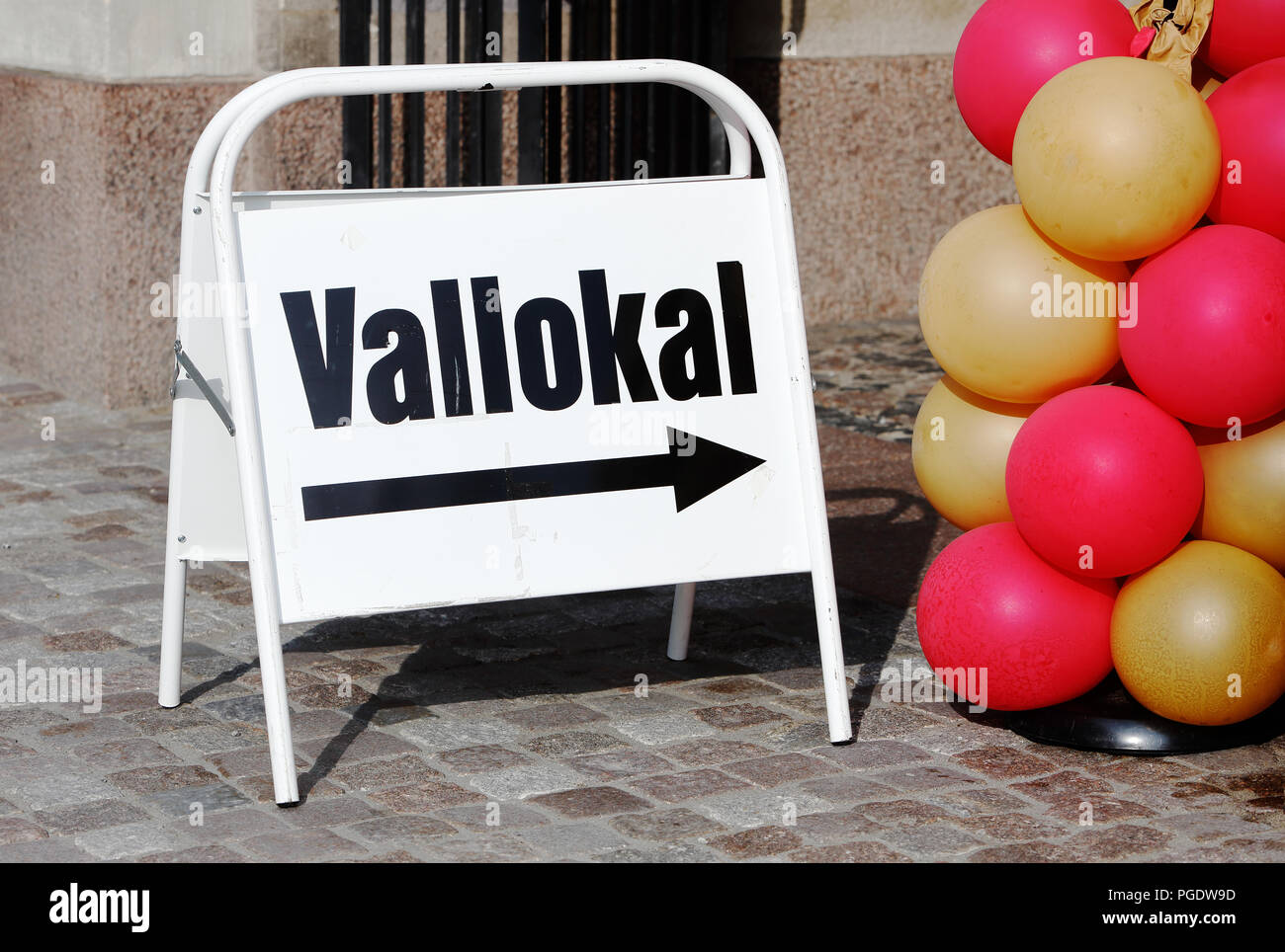 Portatile segno direzionale con il testo in lingua svedese per un seggio in uso per le elezioni generali. Foto Stock
