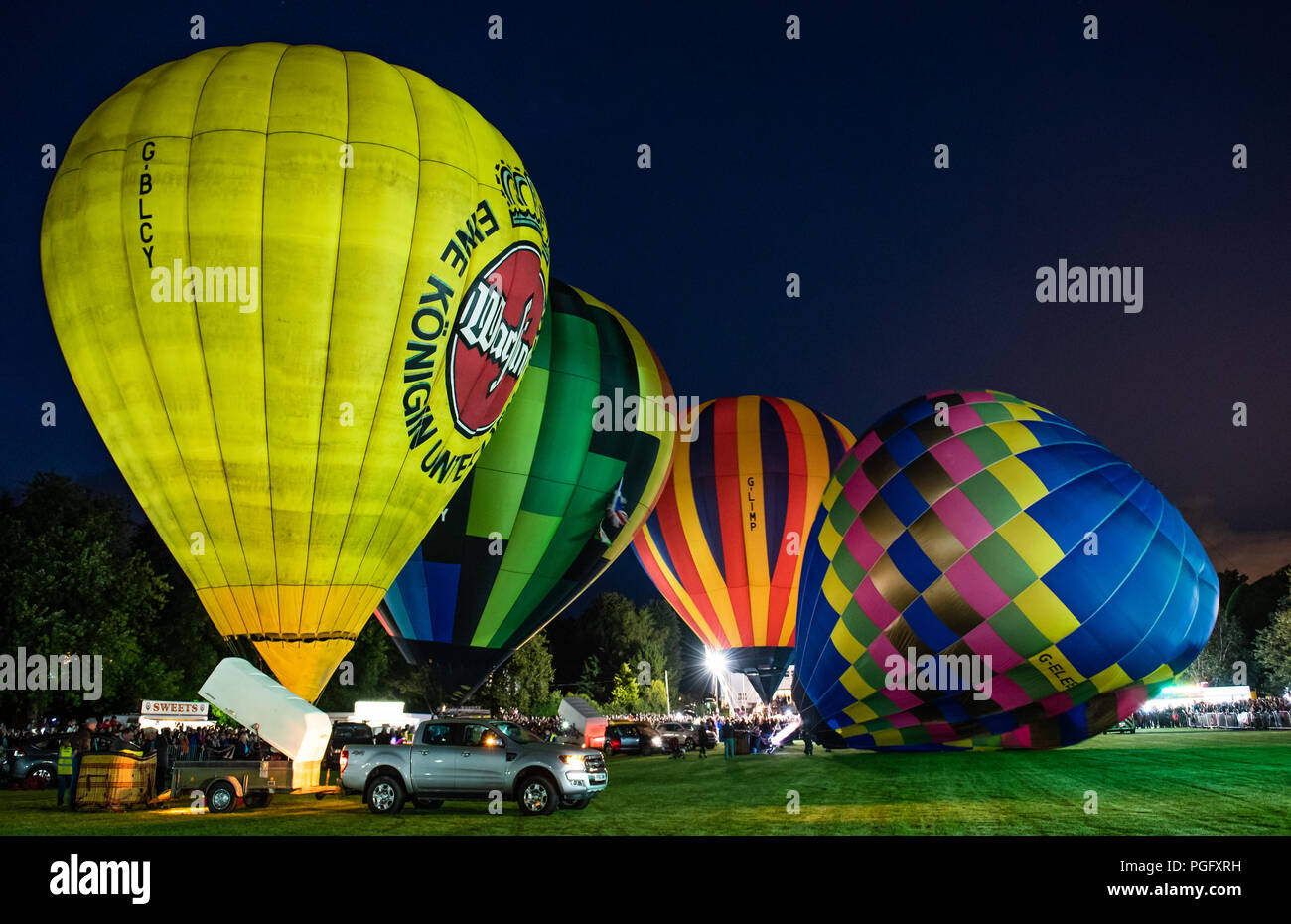 Strathaven, Scozia, 25 Agosto, 2018. "La candela" all'International Balloon Festival è una magica scena di luce e di colore illuminano il cielo notturno con flash dai bruciatori del tethered palloncini in John Hastie Park a Strathaven, Scozia. Credit George Robertson/Alamy Live News Foto Stock