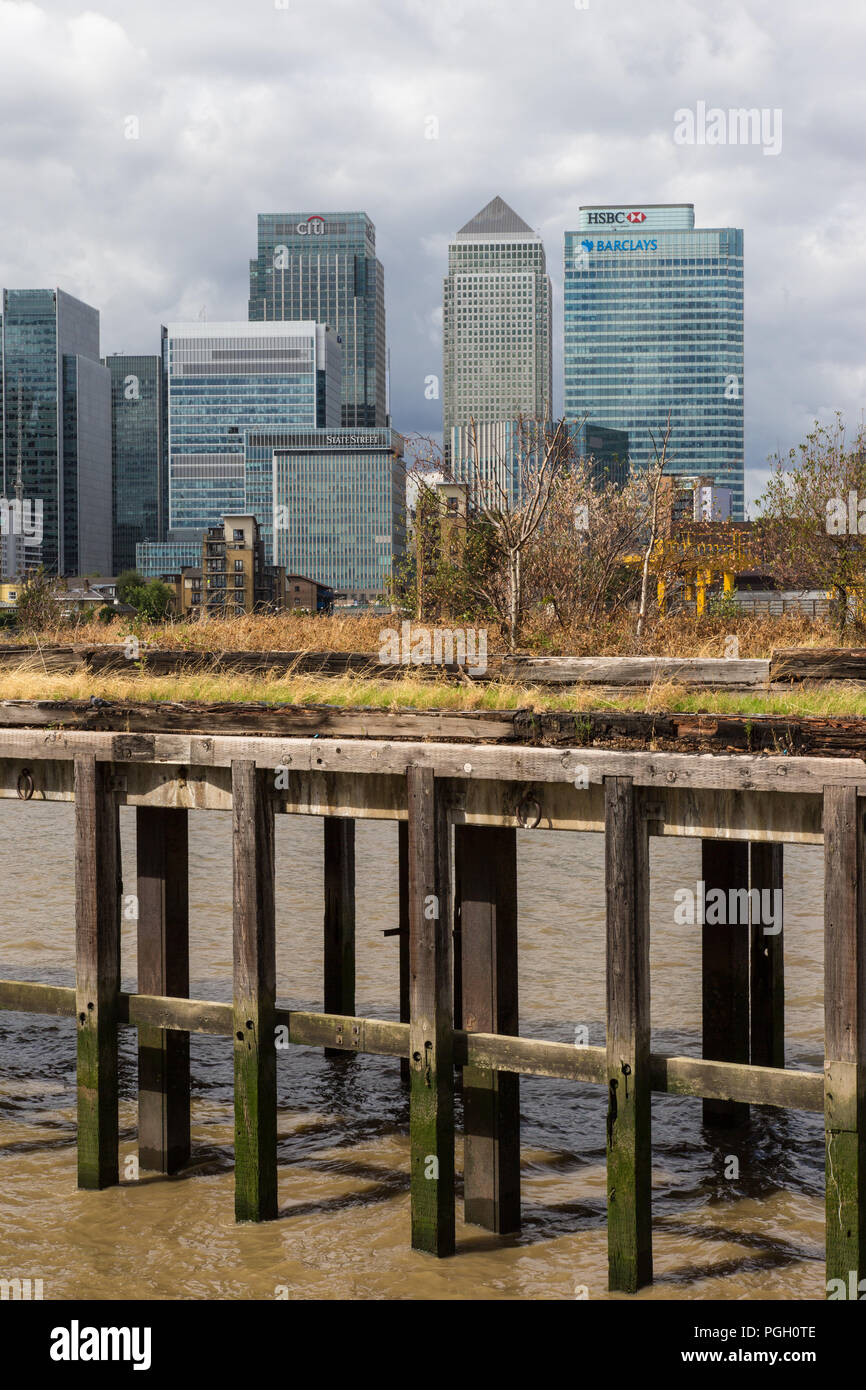 Canary Wharf London - quartiere finanziario in una giornata noosa. Sembra che gli edifici, e l'economia, ecc, ha basi di pali di legno inadeguate. Foto Stock