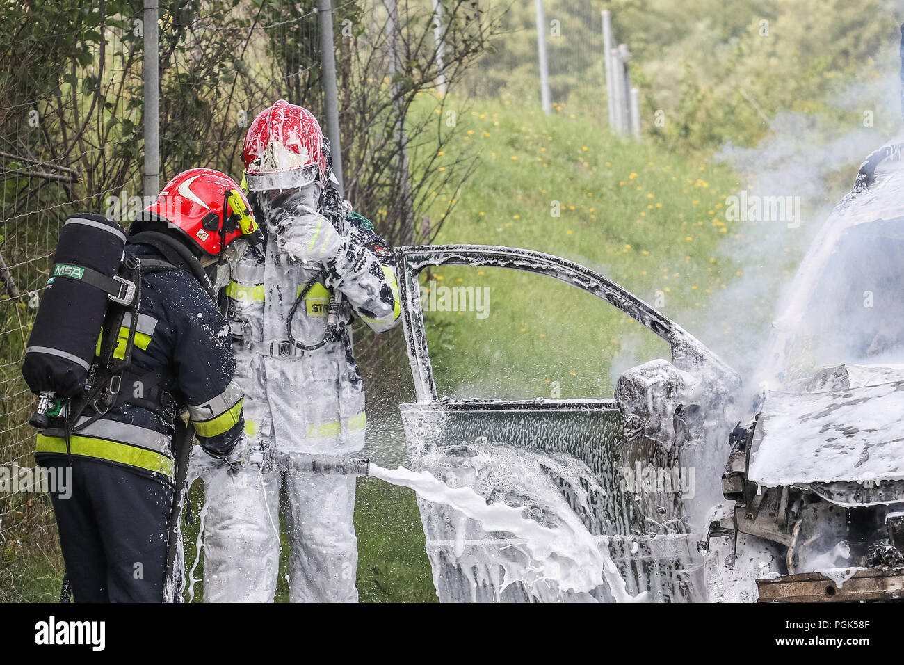 Gdynia, Polonia 27th. Agosto 2018 macchina fuoco sulla S6 - TriCity ringroad a Gdynia. Vigili del fuoco da dello Stato polacco Vigili del Fuoco (Straz Pozarna) sono visibili mentre tenta di controll fire della Renault New Scenic 5 posti auto. Vettura ha cominciato a bruciare violentemente durante la guida. © Vadim Pacajev / Alamy Live News Foto Stock