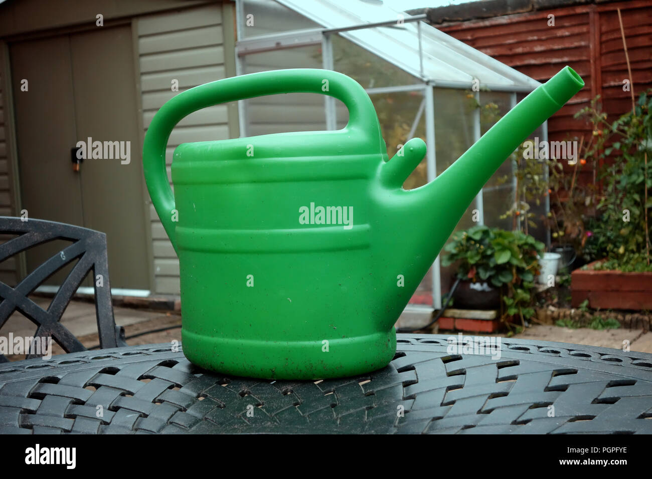 Green Annaffiatoio in plastica in una casa giardino a Rotherham, South Yorkshire, Inghilterra. Foto Stock
