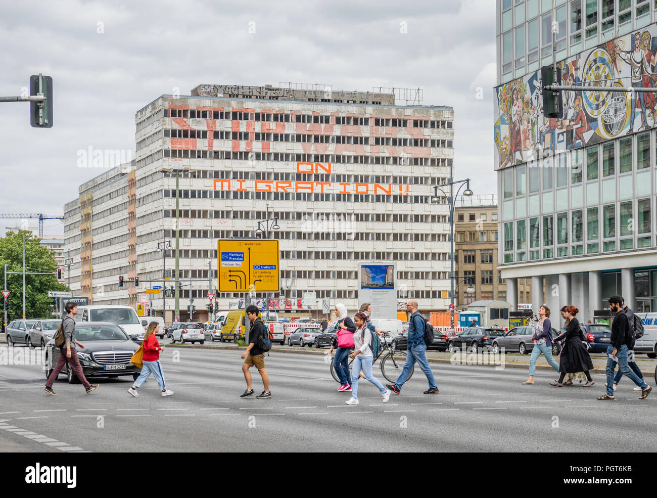 Le persone che attraversano le Otto-Braun Strasse vicino Alexanderplatz con la Haus der Statistik in background, Berlino, Germania Foto Stock