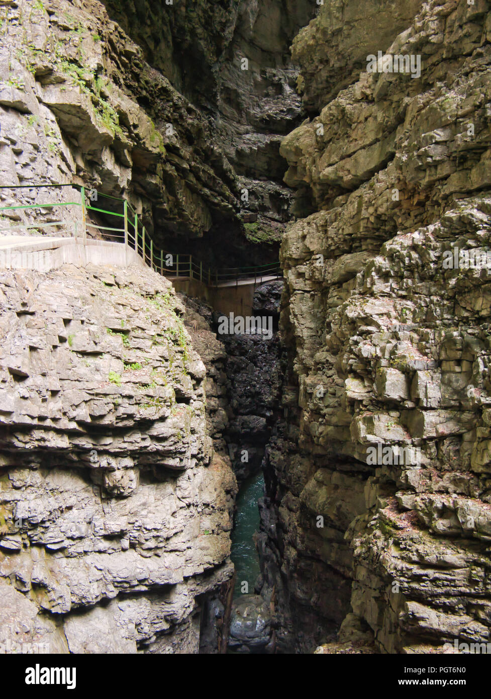 Un percorso attraverso una profonda gola con un recinto verde in Germania Foto Stock