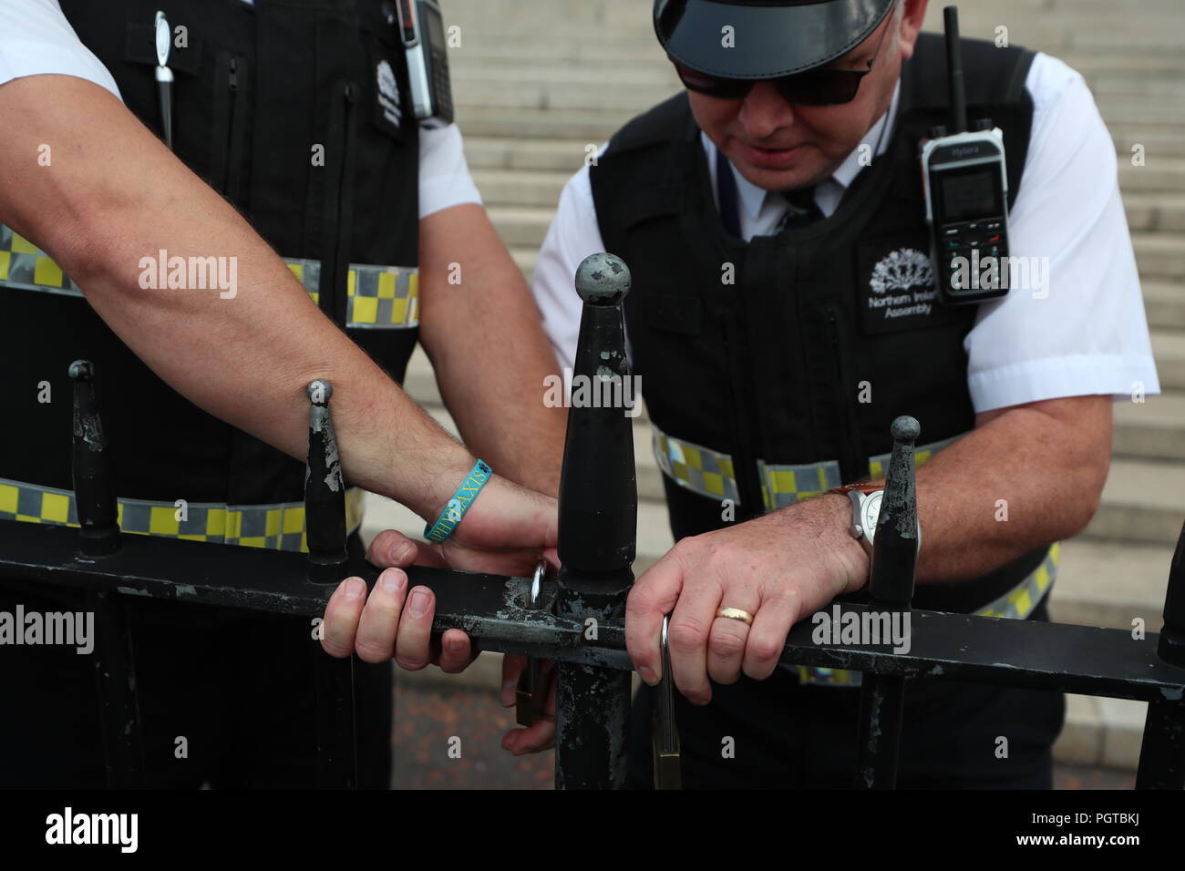 Le guardie di sicurezza bloccare le porte fuori gli edifici del Parlamento di Stormont a Belfast. Il governo ha riconosciuto la profonda frustrazione del pubblico in Irlanda del Nord come la regione ha raggiunto una pietra miliare indesiderati per non-governance. Foto Stock