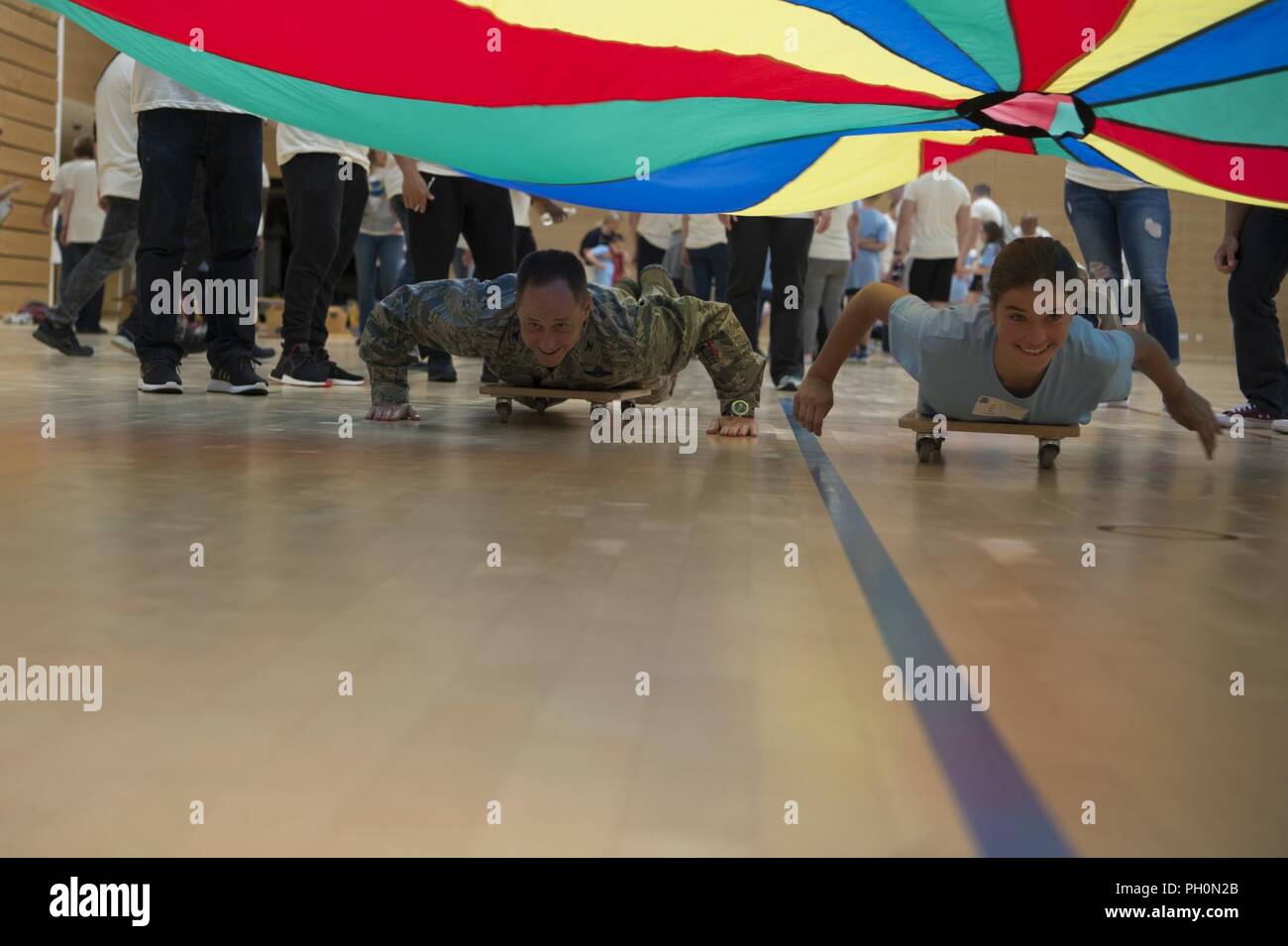 Stati Uniti Air Force Col. Tad Clark, 52nd Fighter Wing vice comandante e Tamara Freilinger, studente di San Martin's School, gara scooter durante la XXVI edizione speciale per i bambini evento della durata di un giorno a Spangdahlem Air Base, Germania, 14 giugno 2018. L'evento richiesta 150 volontari per aiutare i bambini con vari eventi sportivi, pranzo e una cerimonia di premiazione alla fine. Foto Stock