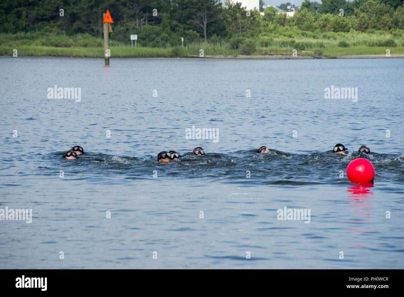VIRGINIA BEACH, Va. (20 giugno 2018) aspiranti guardiamarina nuotare passato una boa durante una baia a nuotare come parte di un'eliminazione degli ordigni esplosivi estate cruise presso l'eliminazione degli ordigni esplosivi gruppo (EODGRU) 2 sede centrale sul giunto di base Expeditionary Little Creek. L'EOD estate crociere è utilizzato per identificare potenziali EOD ufficiali dalla base navale di riserva per la formazione di ufficiali Corps e Stati Uniti Naval Academy prima della loro senior year. Foto Stock