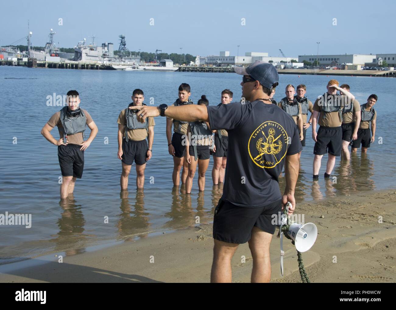 VIRGINIA BEACH, Va. (20 giugno 2018) un'eliminazione degli ordigni esplosivi tecnico assegnato per l'eliminazione degli ordigni esplosivi gruppo (EODGRU) 2 incarica aspiranti guardiamarina prima di una baia a nuotare come parte di un EOD estate crociere a EODGRU sede 2 sul giunto di base Expeditionary Little Creek. L'EOD estate crociere è utilizzato per identificare potenziali EOD ufficiali dalla base navale di riserva per la formazione di ufficiali Corps e Stati Uniti Naval Academy prima della loro senior year. Foto Stock