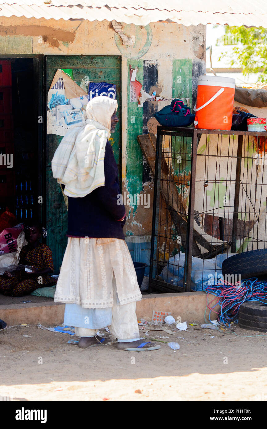 Deserto LAMPOUL village, SENEGAL - Apr 23, 2017: Non identificato uomo senegalesi in abiti tradizionali supporti da dietro in un villaggio vicino al Lampoul De Foto Stock