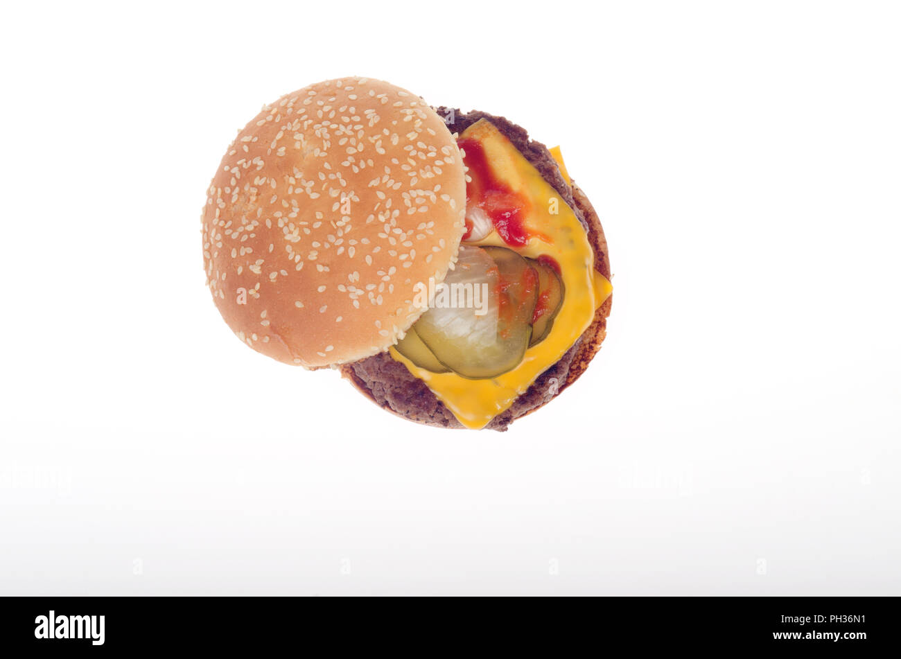 Guardando verso il basso in corrispondenza di un cheeseburger con ketchup, sottaceti e cipolla su un seminate bun Foto Stock