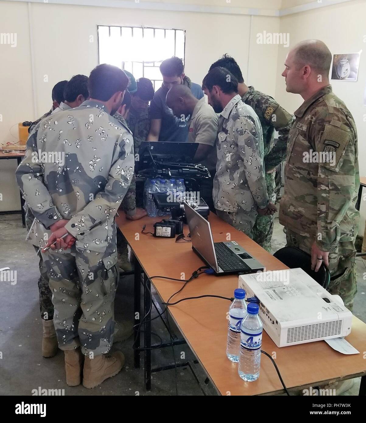 Inoltra una base operativa THUNDER, GARDEZ, AFGHANISTAN -- Esercito nazionale afgano e frontiera afgana vigore l'eliminazione degli ordigni esplosivi (EOD) i soldati guarda un istruttore riparare la MMP-30 EOD robot durante un operatore di robotica Manutenzione e riparazione corso, Giugno 25-28. Gli studenti hanno imparato come risolvere i problemi e di effettuare la riparazione di base del robot utilizzati da EOD soldati per indagare e disarmare ordigni esplosivi artigianali. Foto Stock