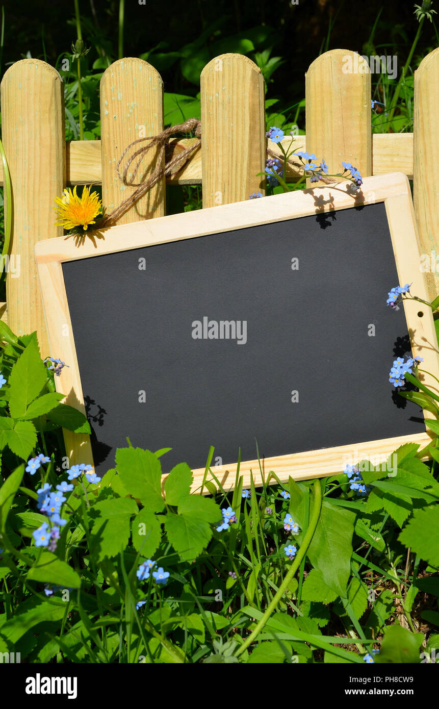 Segno con i fiori sulla recinzione Foto Stock