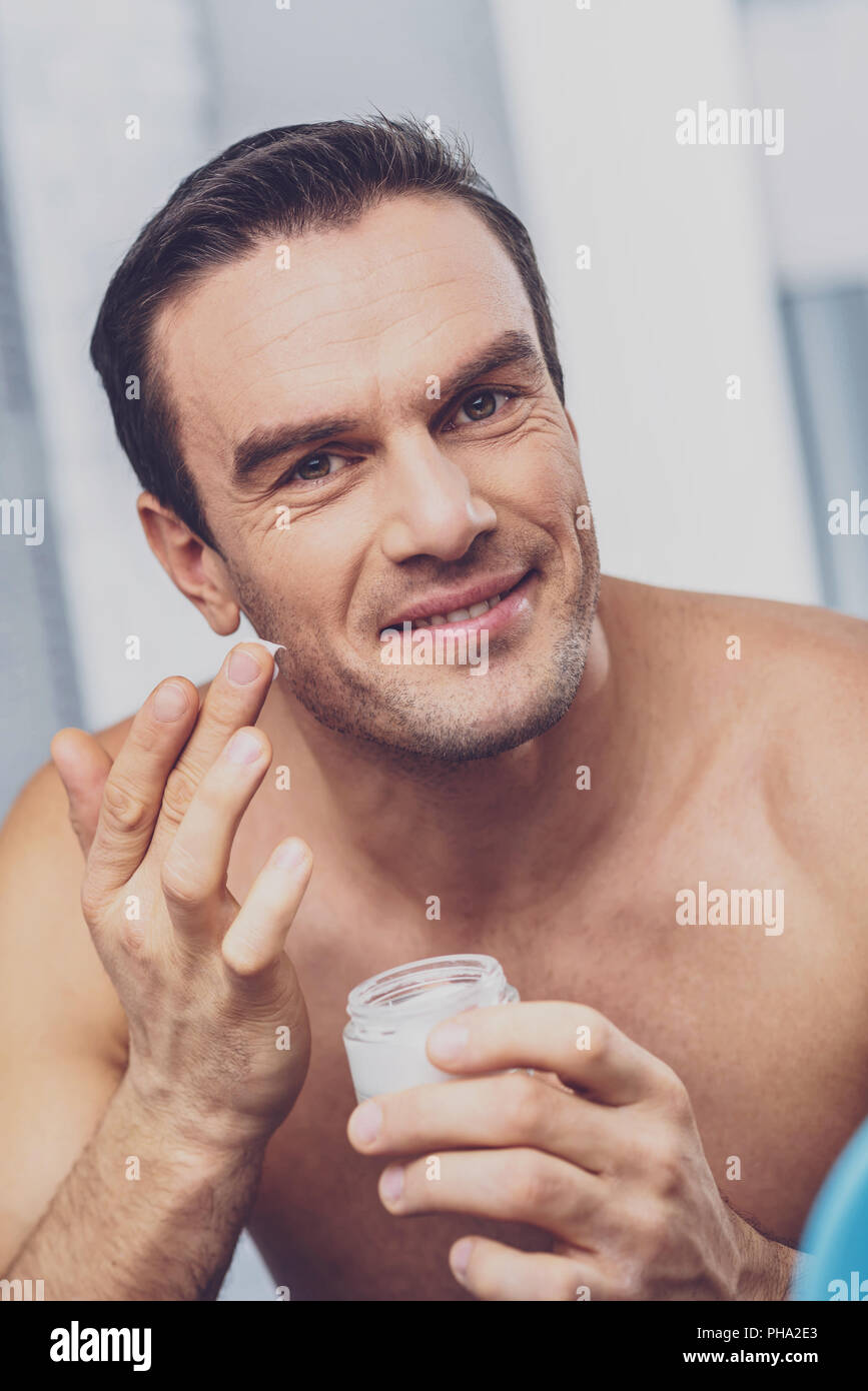 Interessante l'uomo con la faccia delle setole in piedi nel bagno Foto Stock