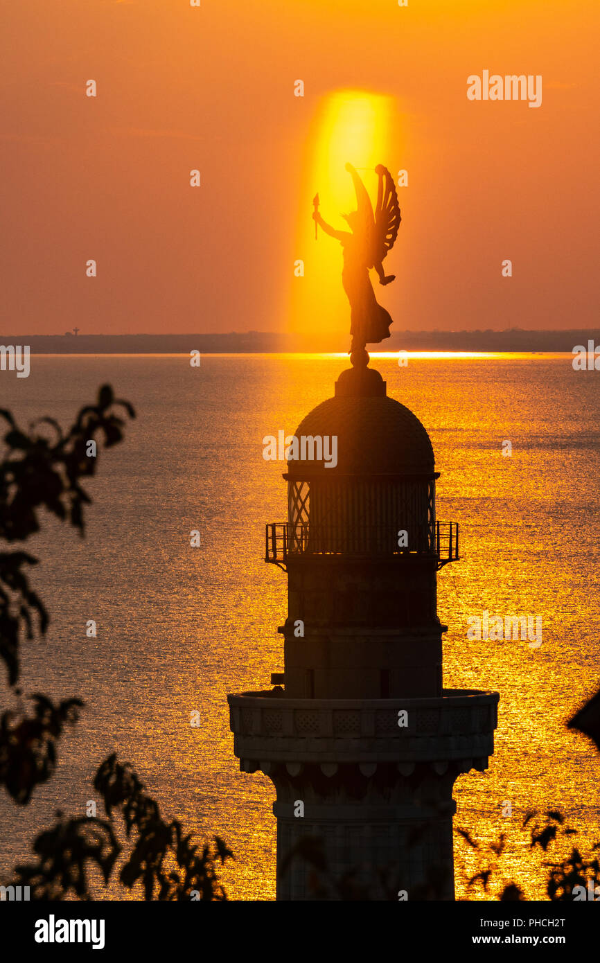 Trieste, 19 agosto 2018. Trieste il Faro della Vittoria faro) al tramonto. La Vittoria Alata (Vittoria alata) statua in bronzo su Foto Stock
