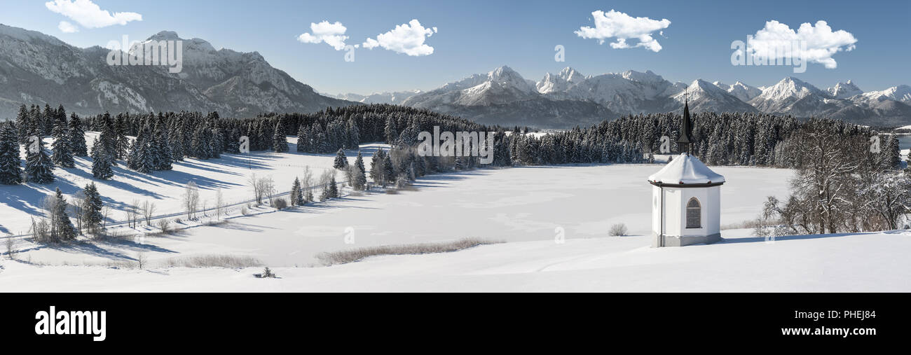Panorama del paesaggio in Baviera con montagne delle Alpi e la cappella romantica Foto Stock