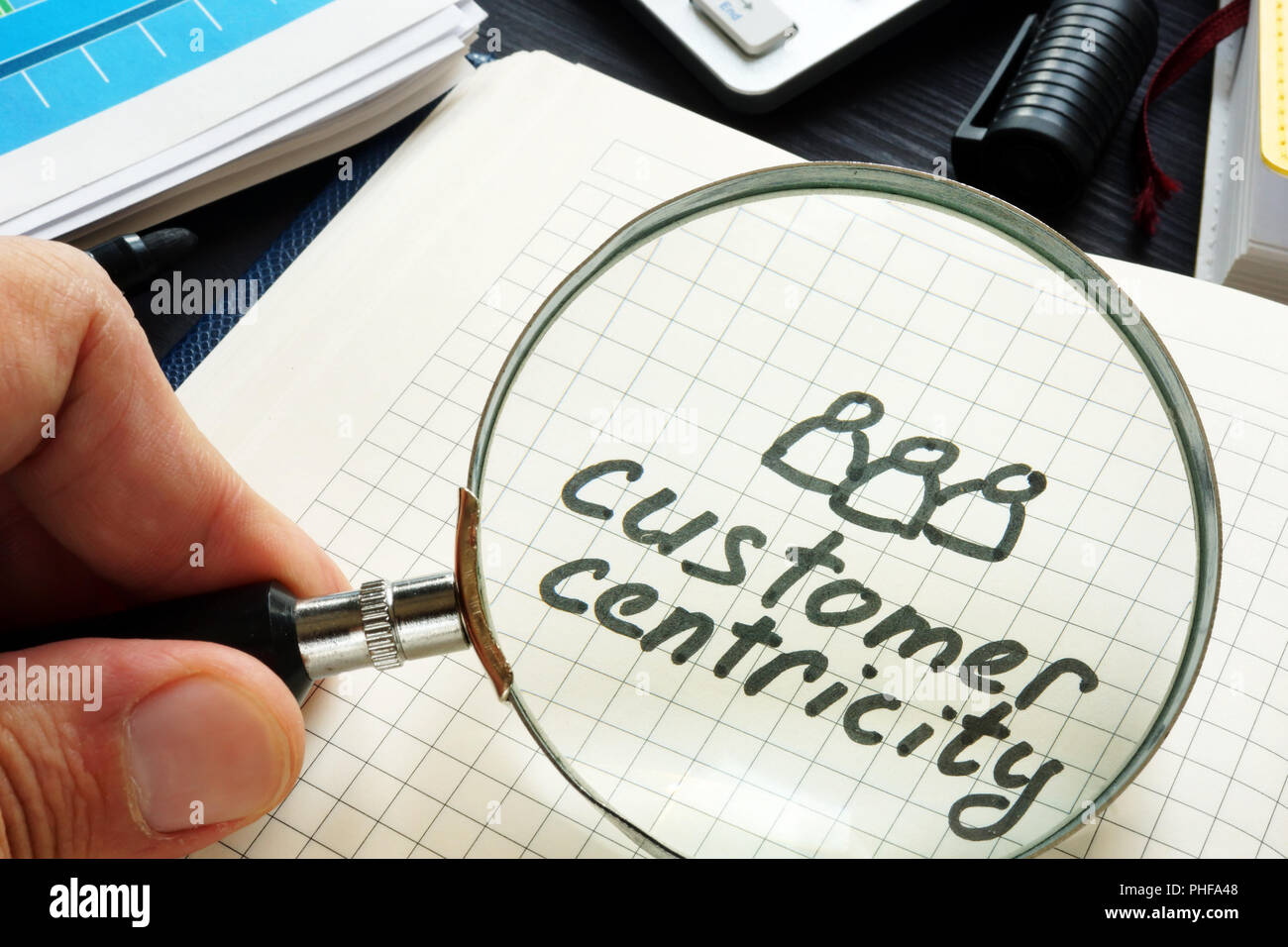 Centralità del cliente scritta a mano in un blocco note. Foto Stock