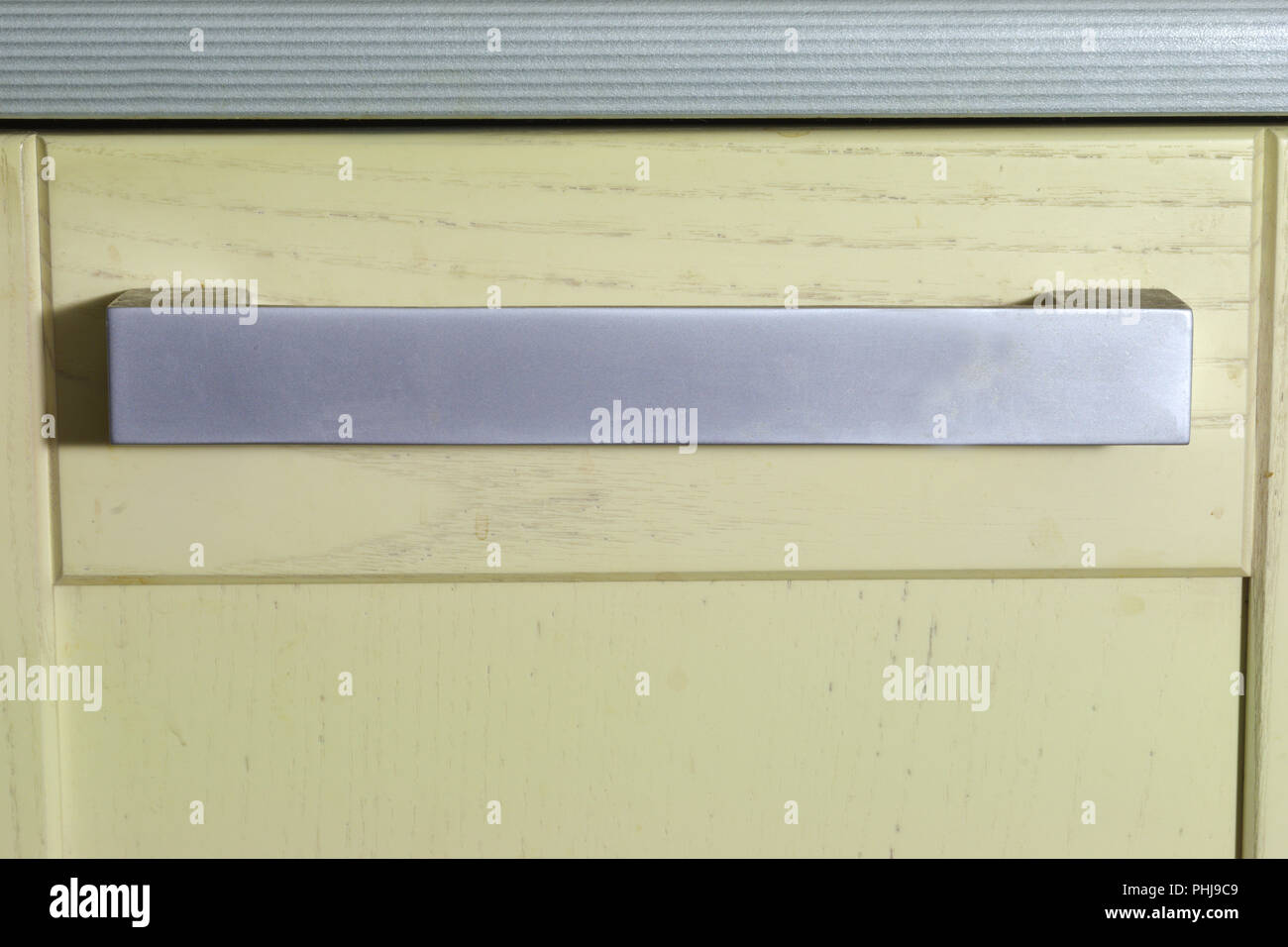 Arco piatto stile tirare la maniglia sulla facciata di mobili da cucina. Forte Pomello in metallo e in legno sportello di armadietto Foto Stock