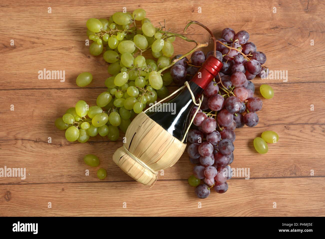 Bottiglia di vino rosso e il grappolo di uva - primo piano Foto Stock