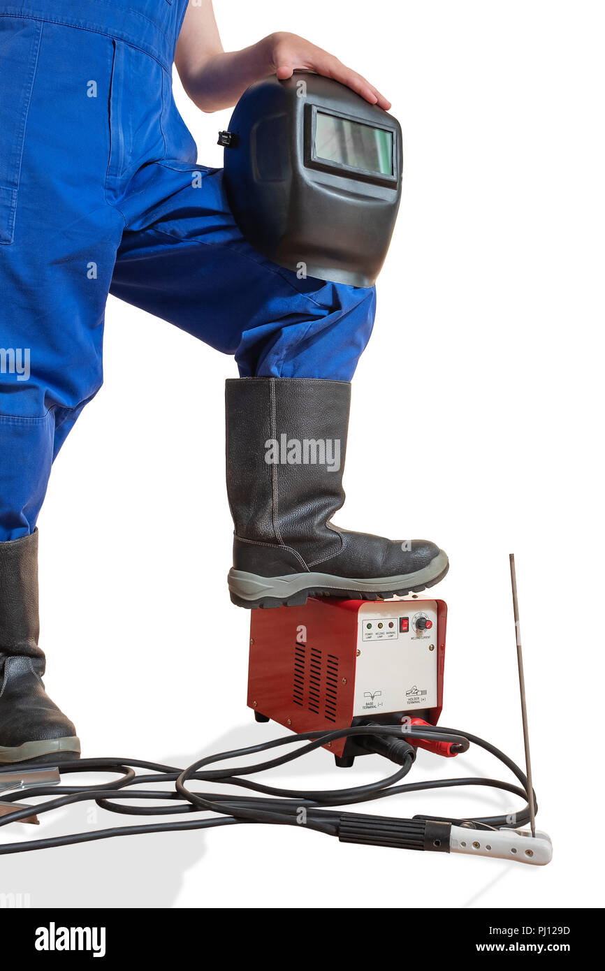 L'immagine pubblicitaria di un corpo inferiore del lavoratore con utensile di saldatura. Immagine della parte inferiore di un corpo umano in abiti e scarpe da lavoro. T Foto Stock