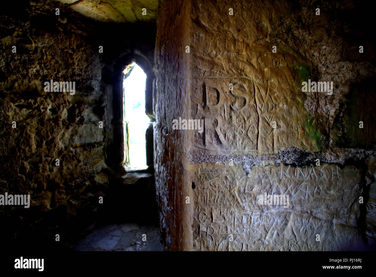 Antichi graffiti su un medievale con mura in pietra Foto Stock