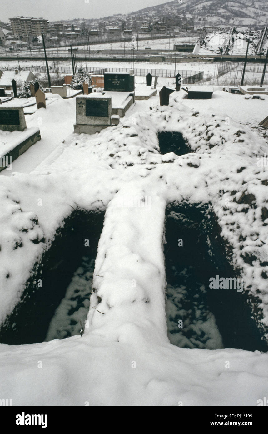 4 Marzo 1993 durante l'assedio di Sarajevo: uno strato di neve segna fresco tombe scavate in un angolo del cimitero di Lion, appena al di sotto dell'Ospedale Kosevo. Foto Stock