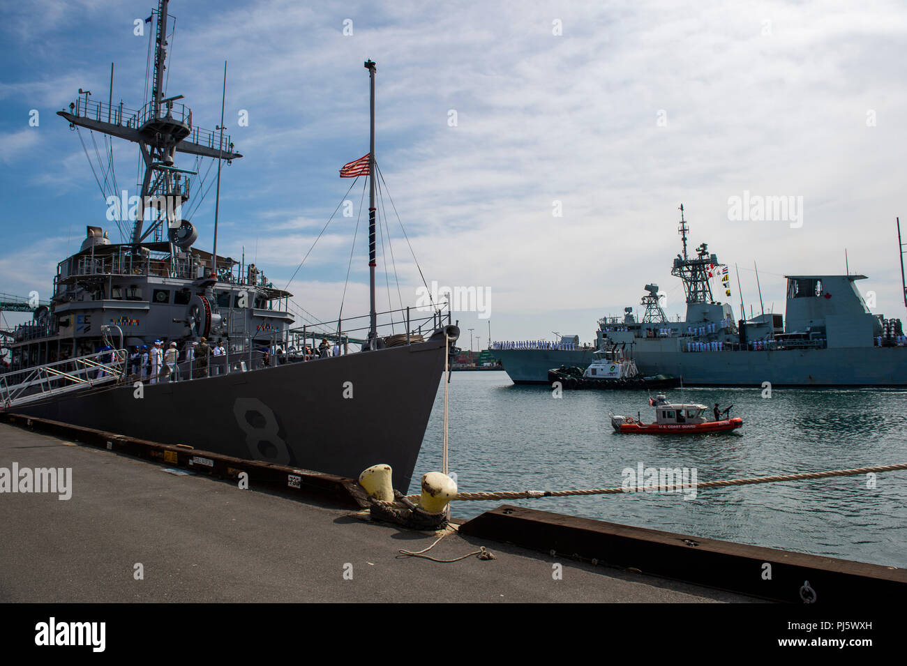 La USS Scout (MCM 8) è una nave di contromisure minerarie di classe Avenger e la HMCS Ottawa (FFH 341) è una fregata classe Halifax della Royal Canadian Navy. L'immagine d'archivio registra i marinai che passano onori tra le navi quando arrivano per le attività navali multinazionali della Los Angeles Fleet Week. Foto Stock