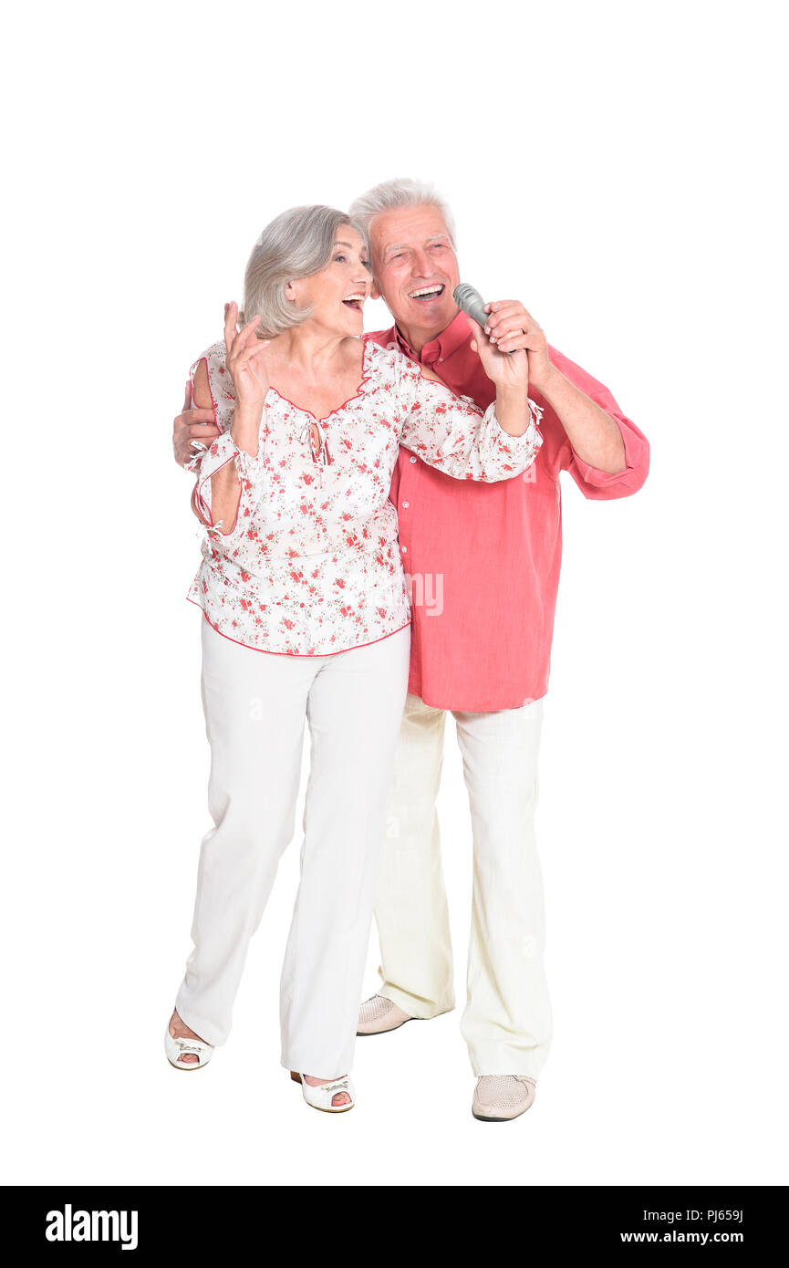 Ritratto di coppia senior cantando su sfondo bianco Foto Stock