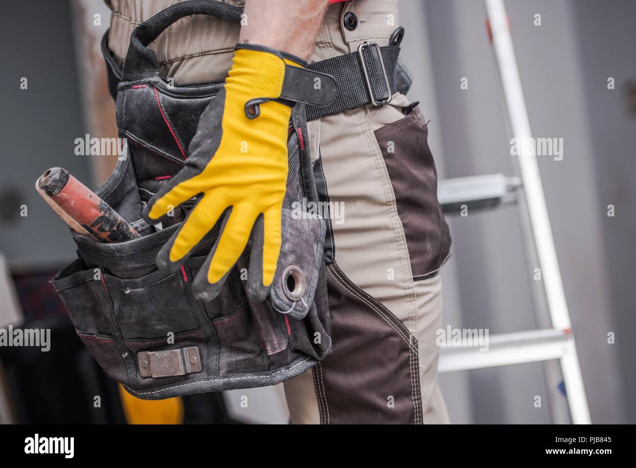 Costruzione lavoro contraente. Cinghia di strumenti di ingrandimento. Industria edile. Foto Stock