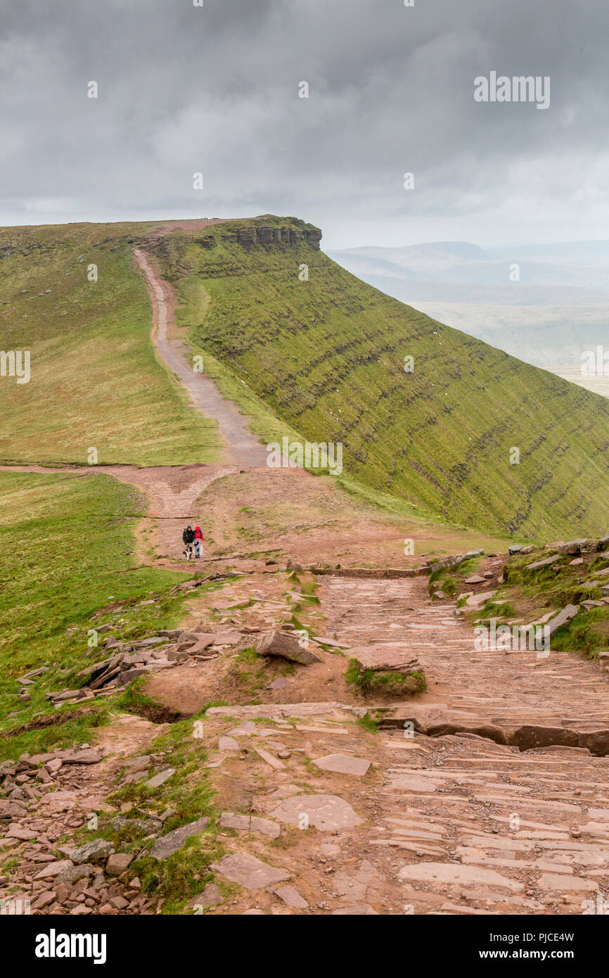 Walkers avvicinarsi al vertice di Pen-y-ventola (il punto più alto sul Brecon Beacons e nel sud della Gran Bretagna) con mais Du oltre, Powys, Wales, Regno Unito Foto Stock