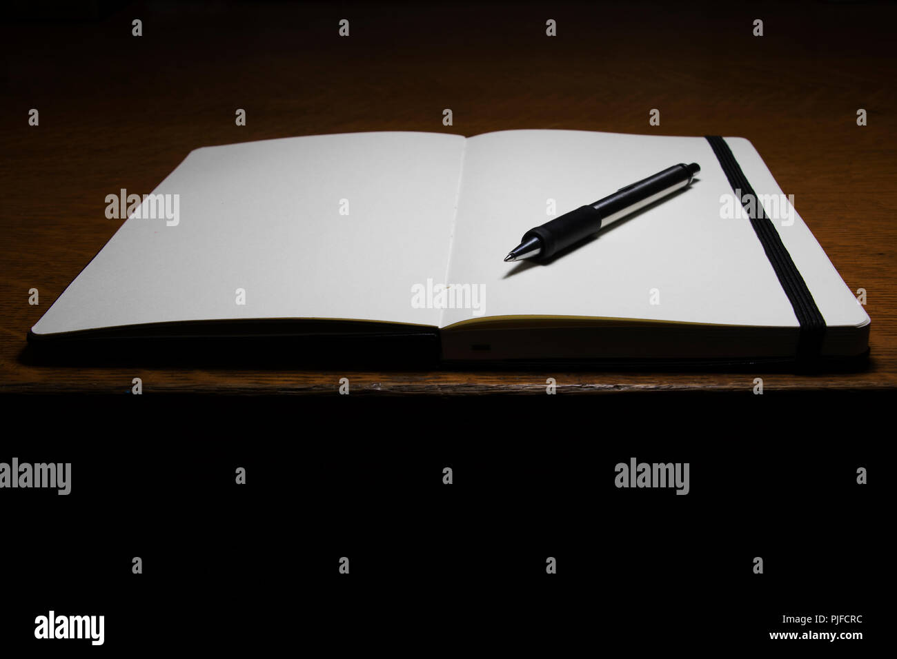 Diario di viaggio su una scrivania in legno. Riflettendo e contemplando sul passato presente e futuro. La scrittura di un diario delle cose che hanno sperimentato. Foto Stock