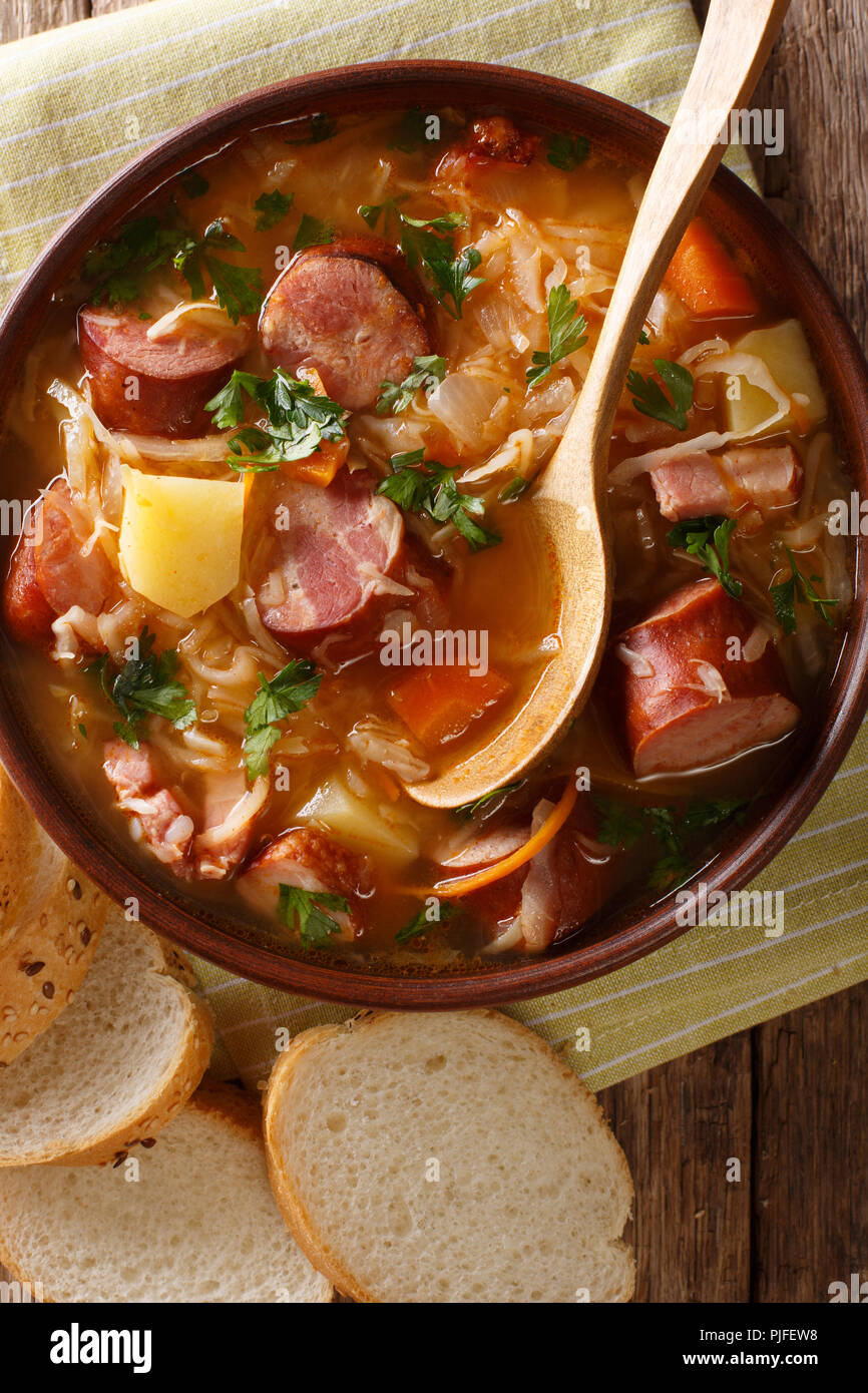 Ceco tradizionale zelnacka zuppa di crauti con salsicce close-up in una ciotola sul tavolo. verticale in alto vista da sopra Foto Stock