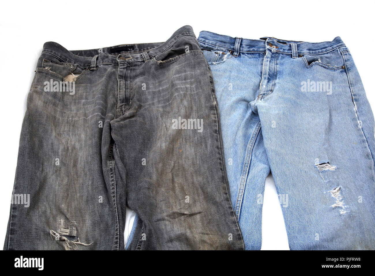 Due coppie di vecchi e consunti Jeans uno nero uno blu Foto Stock