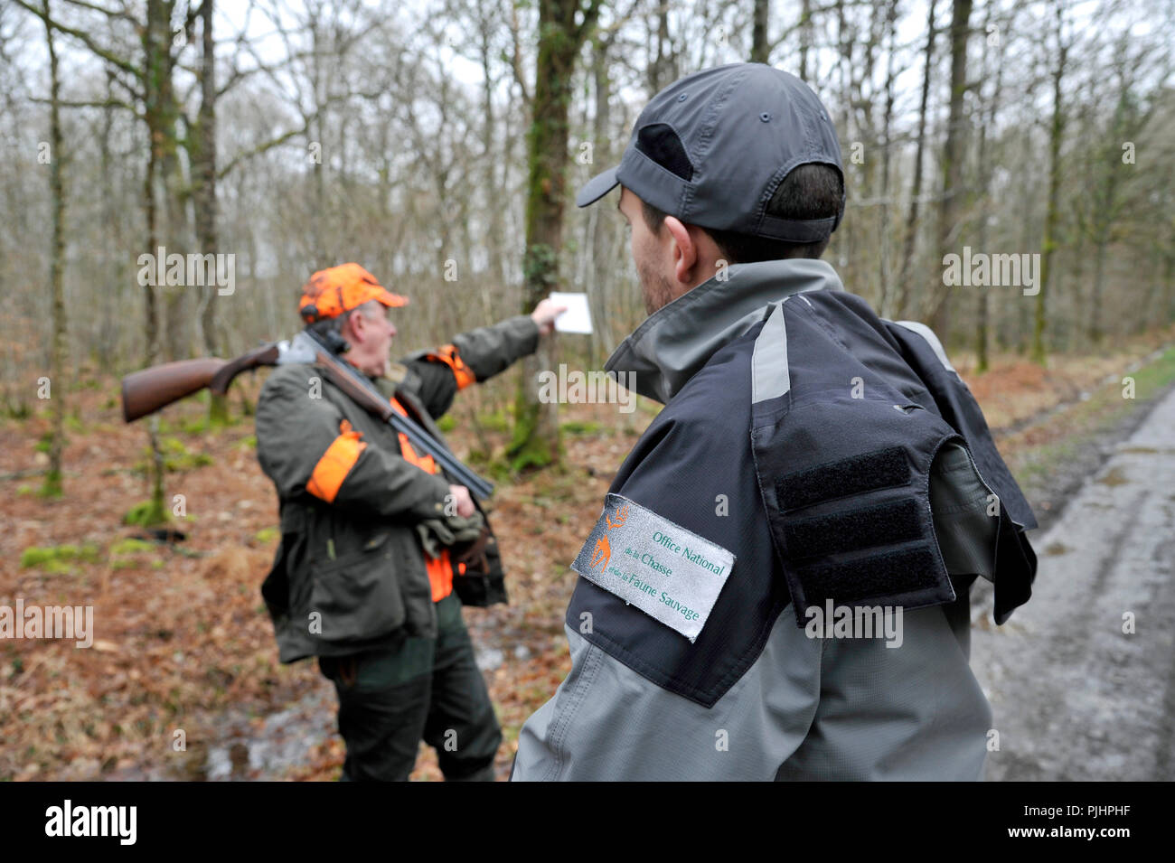 Francia, caccia e security, ufficiale francese di politica ambientale e cacciatore durante una battuta di caccia nel dipartimento Loire-Atlantique. Foto Stock