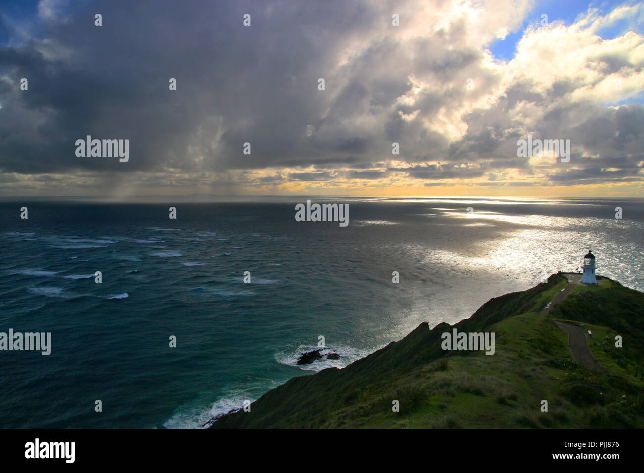 Tempesta tropicale oceano nuvole ciclone sopra l'Oceano Pacifico, drammatica seascape con Cape Reinga Lighthouse pietra miliare della Nuova Zelanda settentrionale punto di più Foto Stock