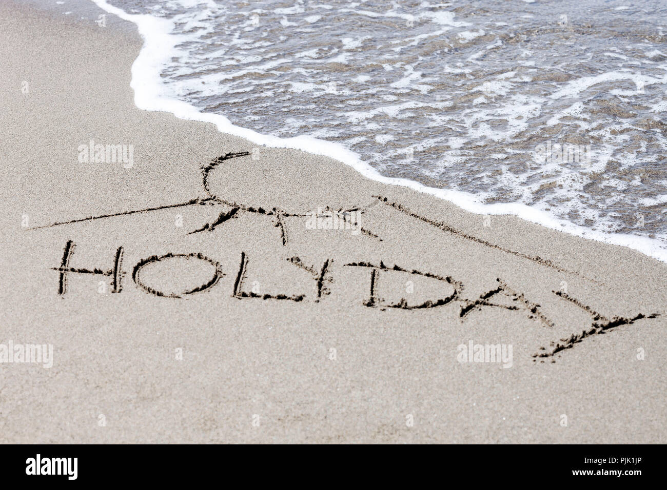 Lettering "Vacanza" sulla spiaggia Foto Stock