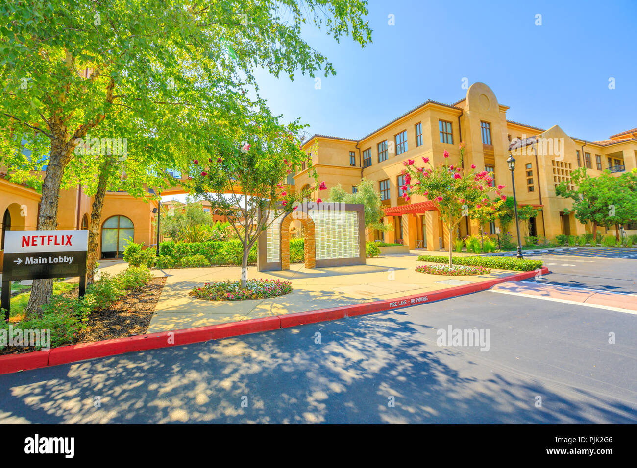 A Los Gatos, California, Stati Uniti - Agosto 12, 2018: Segno di Netflix a edifici in stile spagnolo di Netflix, sede di streaming di gigante nella Silicon Valley. Edificio di Netflix A e B: lobby principale. Foto Stock