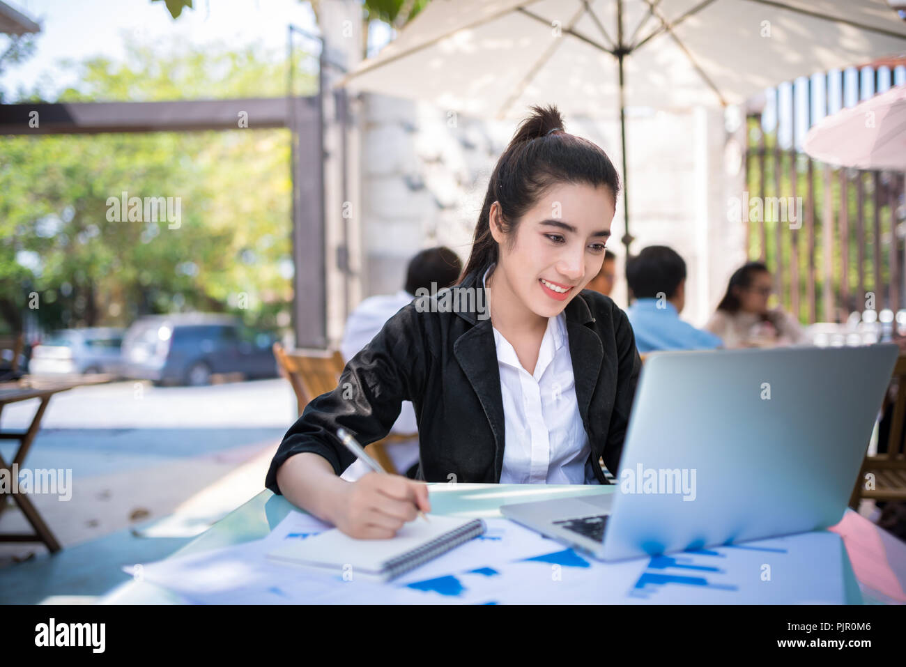 Busy business giovane donna che lavorano sulla scrivania con computer portatile in coffee shop Foto Stock