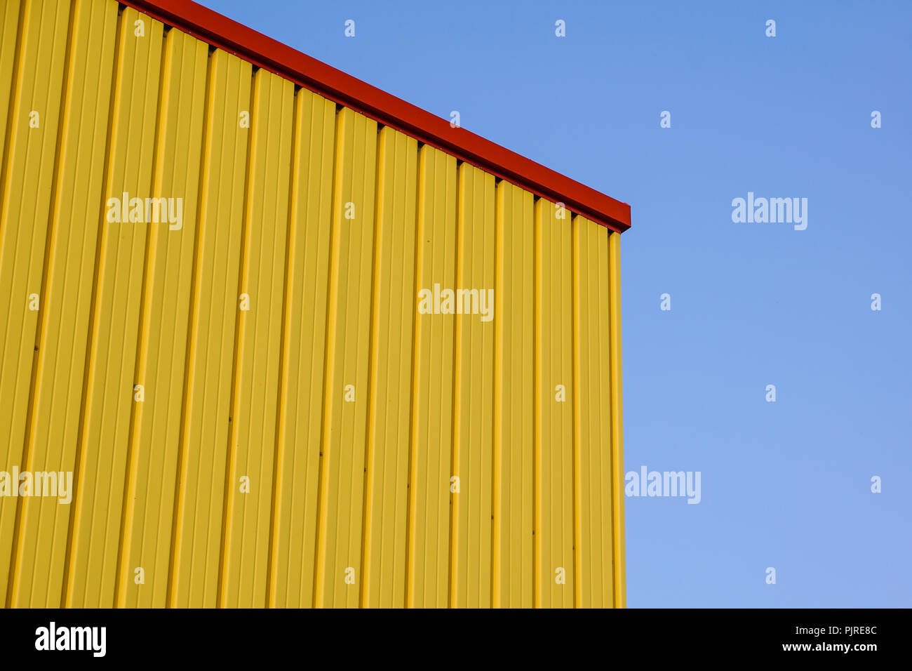 Metallo giallo costruzione di pannello di parete, dell'edificio con l'azzurro del cielo. Foto Stock