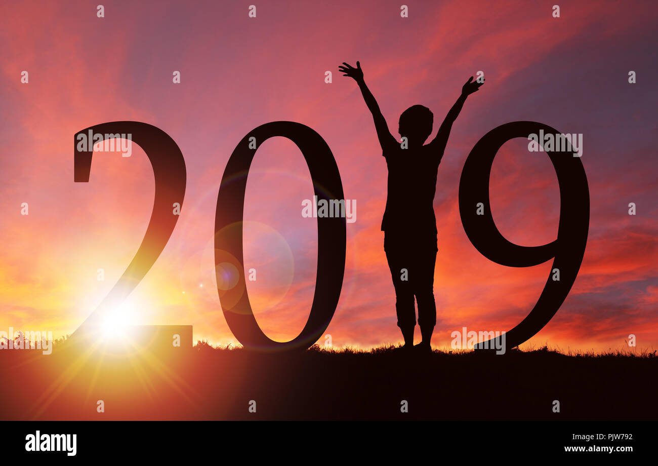 2019 Anno Nuovo silhouette di una ragazza con le mani sollevate durante il golden all'alba o al tramonto con copia spazio. Concetto di gioia, di lode, di culto, di collegamento con Foto Stock