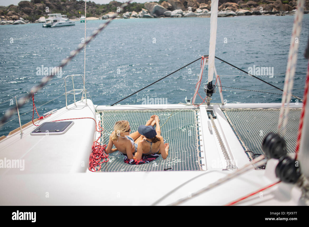 Due giovani donne rilassante sulla barca a vela, Isole Vergini Britanniche Foto Stock
