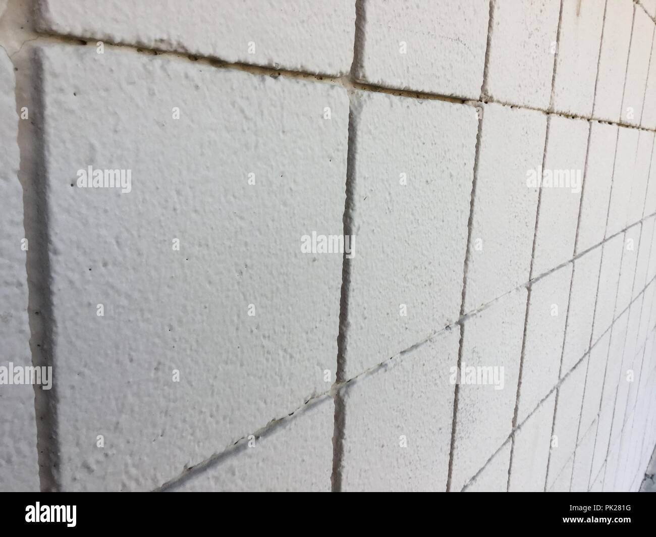Blocco quadrato a parete, closeup in corrispondenza di un angolo della parete si distende. Foto Stock
