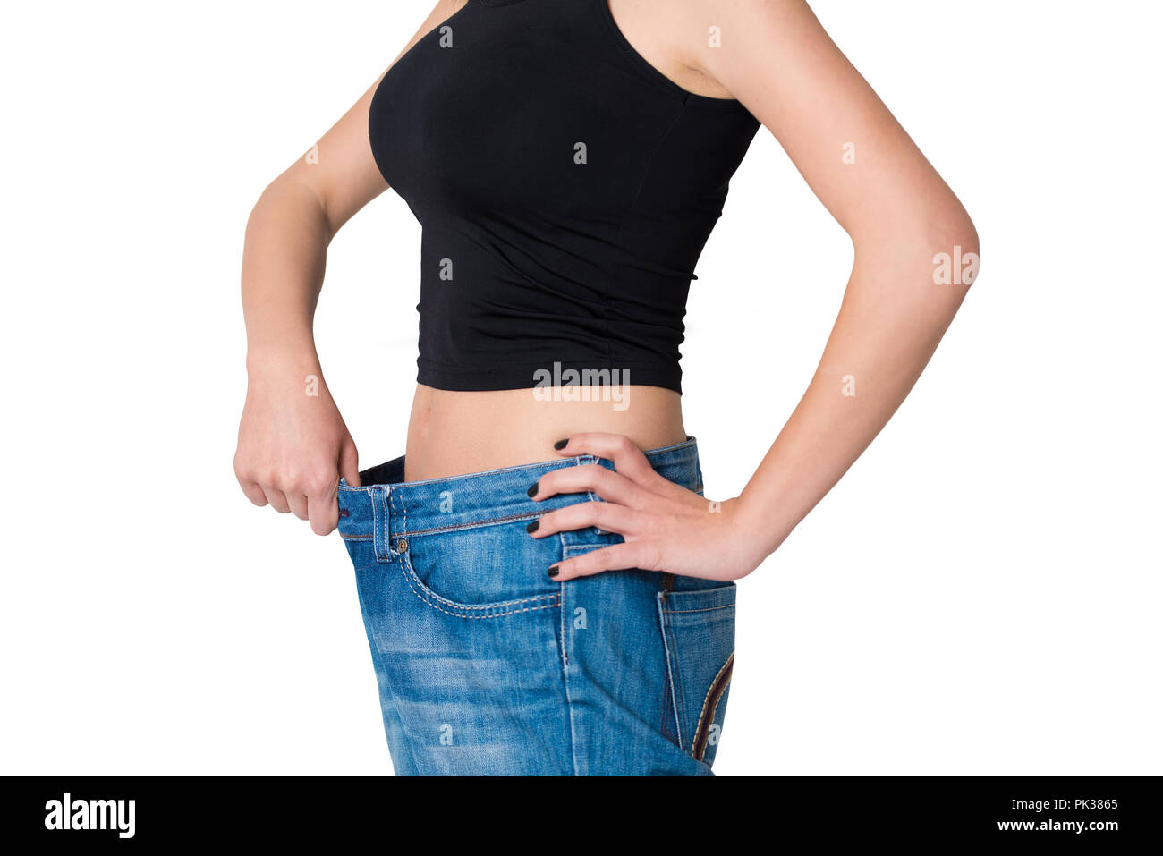 Donna isolato perso peso e i suoi pantaloni sono troppo grandi, uno stile di vita sano Foto Stock