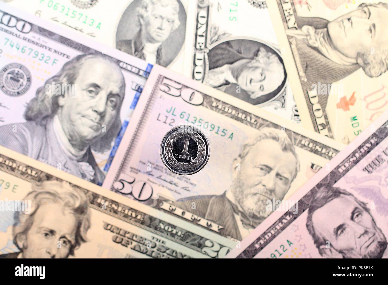 Polish Zloty moneta sullo sfondo di banconote americane Foto Stock
