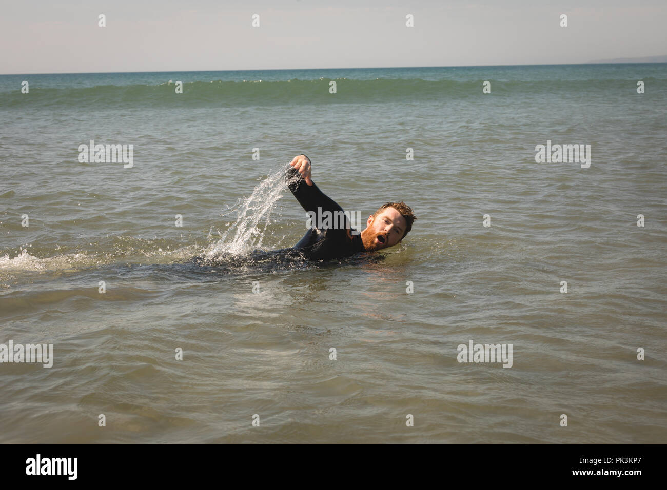 Surfer nuoto in mare Foto Stock