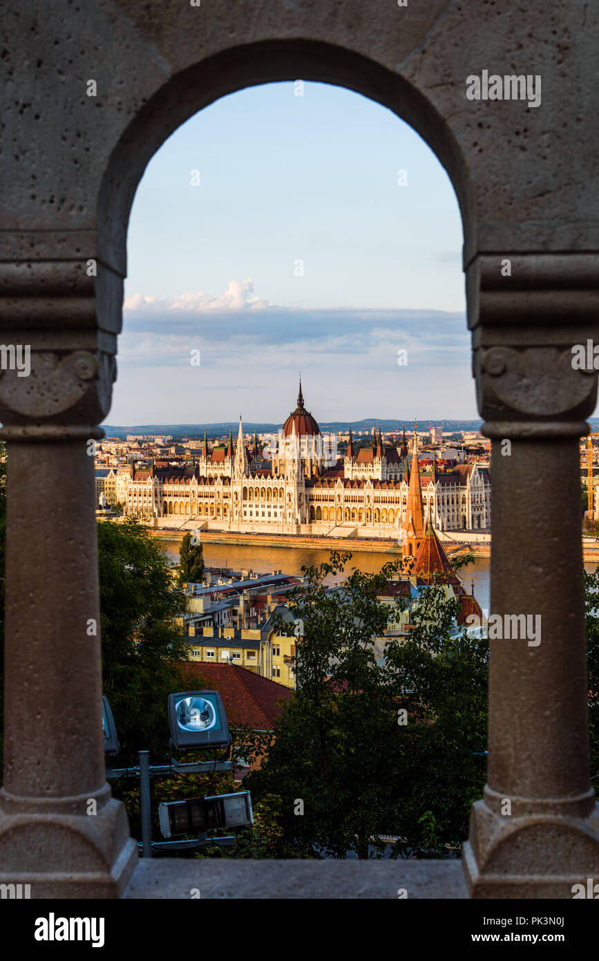 Parlamento ungherese di Budapest attraverso la fortezza di recinzione al tramonto Foto Stock