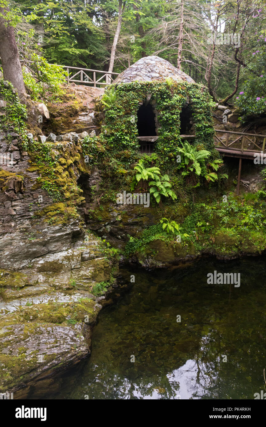 L'Hermitage di Tollymore Forest Park, è un grazioso rifugio di pietra coperta di edera su un riverwalk accanto al fiume Shima, Newcastle, County Down, N. Foto Stock